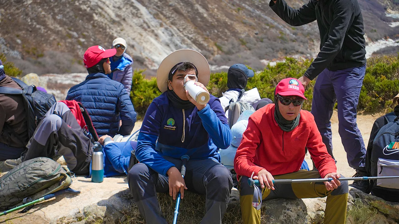 Trekker drinking water during a Himalayan trek to stay hydrated
